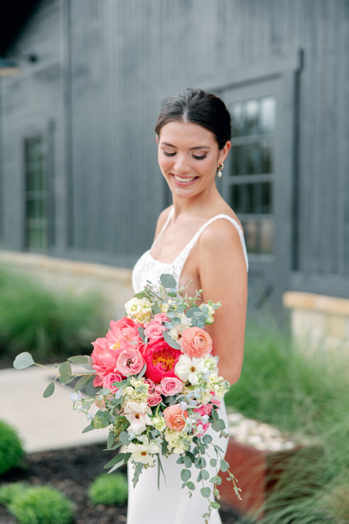 Bride and beautiful florals outside of Morgan Creek Barn in Dripping Springs, Texas. 