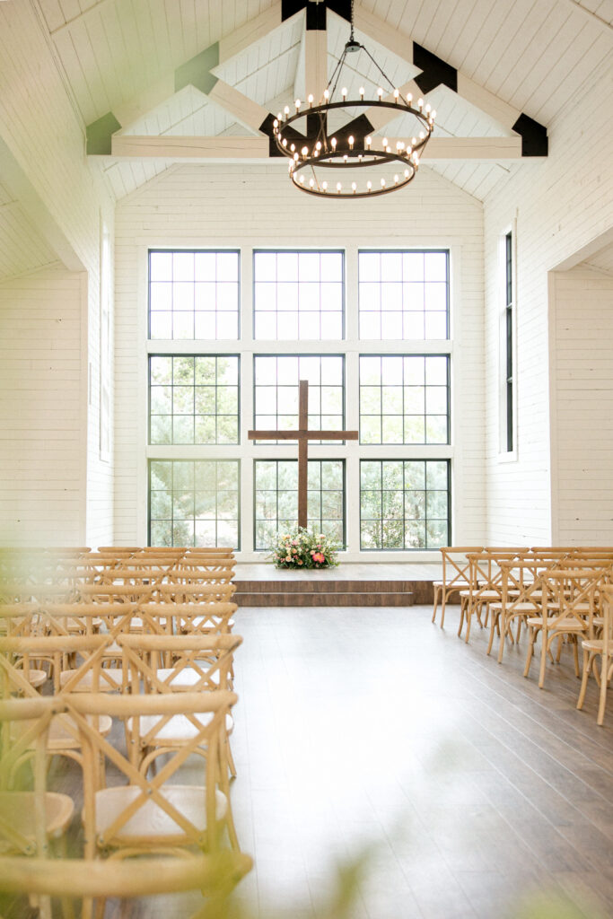 Morgan Creek Barn's main hall with it's stunning window views and modern chandeliers in Dripping Springs, Texas