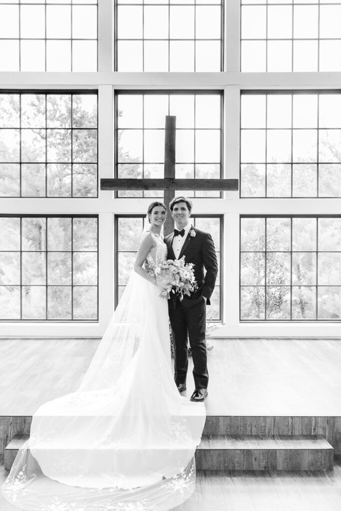 Bride and Groom standing at the altar in the high ceiling and spacious ceremony hall at Morgan Creek Barn.