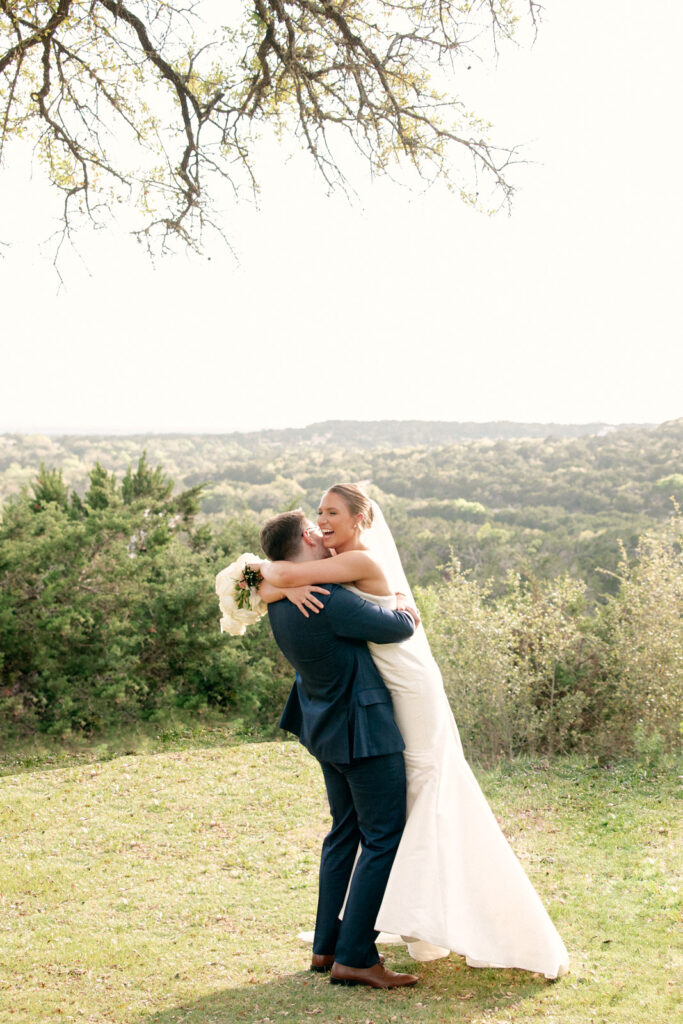 Canyonwood Ridge is a stunning wedding venue in Dripping Springs, Texas, with indoor and outdoor spaces and impressive hill country views.
