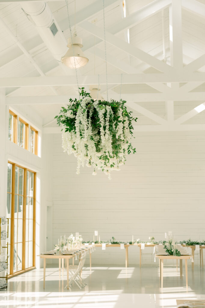 A large suspended floral display in the reception hall at the wish well house.  