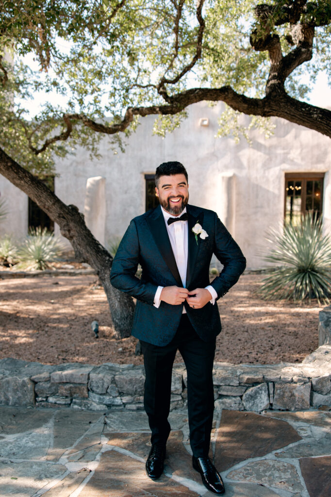 Groom in classic tux at Lost Mission Venue smiling for photos.