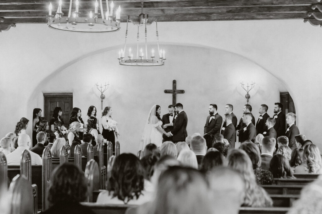 Bridal party in the front of the chapel at lost mission during wedding ceremony. 