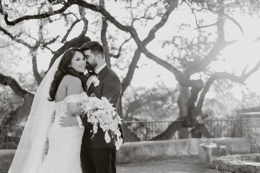 Bride and groom embracing eachother at golden hour on their wedding day at Lost Mission Wedding Venue. 