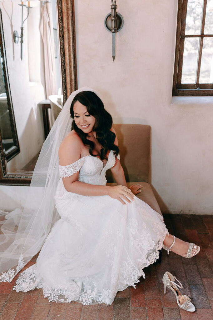 Bride getting ready in spanish inspired bridal suite at Lost Mission Wedding Venue. 
