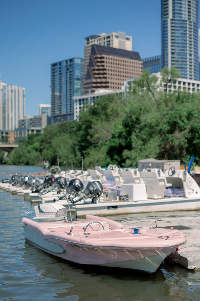 A pink retro boat in Austin by Lois M Photography in downtown on Lady Bird Lake. 