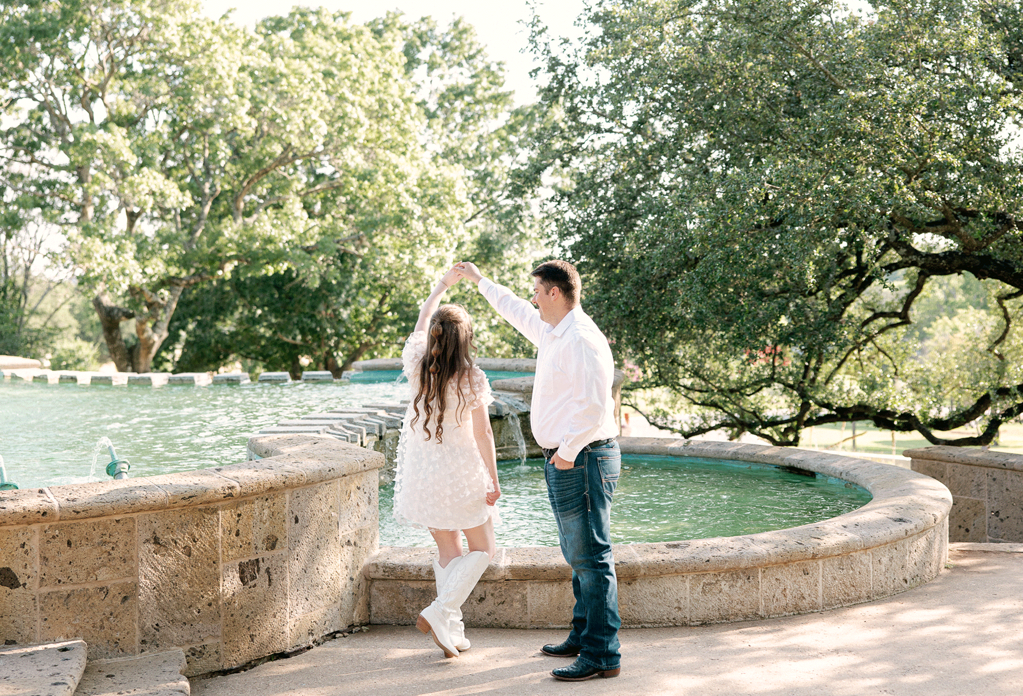Engaged couple twirling at one of the best proposal locations in Austin.