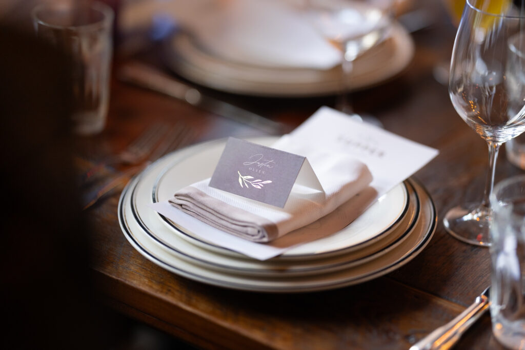 Dinner plate with name card at reception in Swiggle Key room at Hotel Emma Wedding Venue.