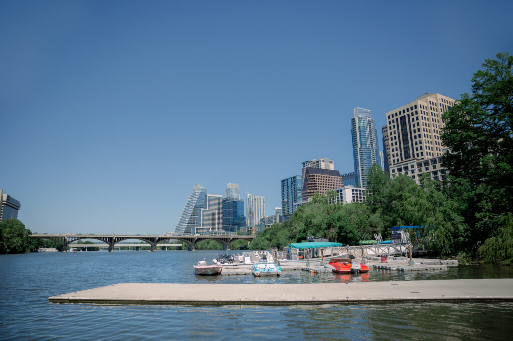A wide shot of the Retro Boats ATX which is one of the best places to propose in Austin with a beautiful view of The Austin Skyline! 