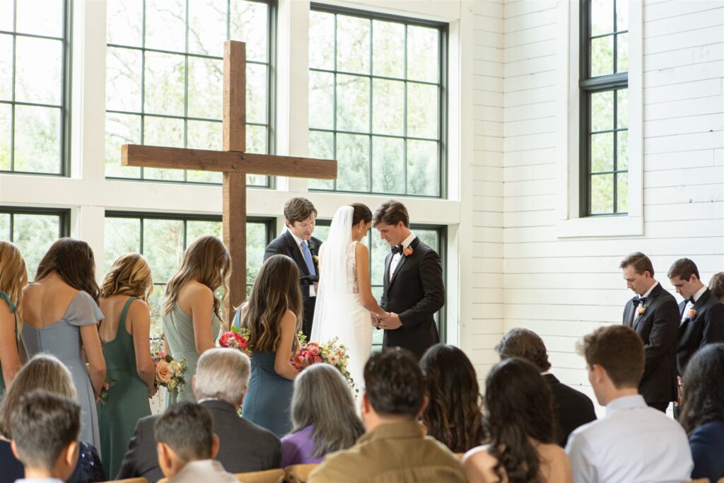Bride and groom during ceremony at Morgan Creek Barn in Dripping, Springs