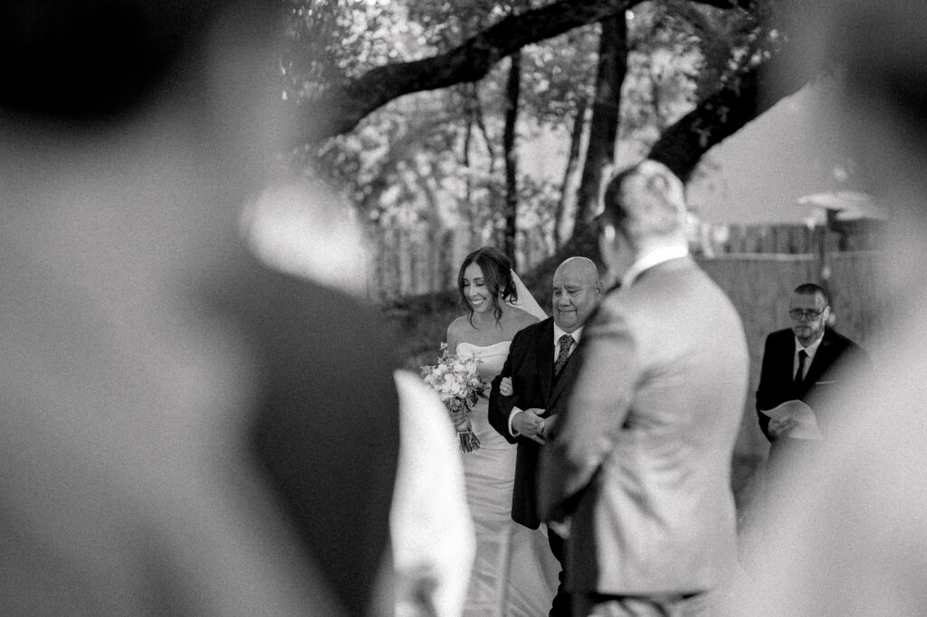 Bride walking down the aisle with her father during her wedding at the Veranda in San Antonio