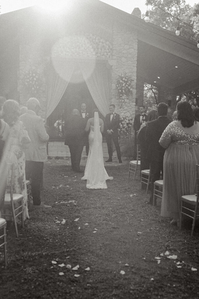 The back of bride's dress after walking down the aisle at her stunning wedding located at the Pavilion site at the Veranda San Antonio