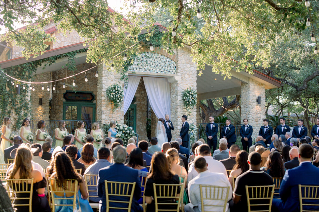 Wedding ceremony taken at the Veranda by Lois M Photography showcasing bride and groom and bridal party