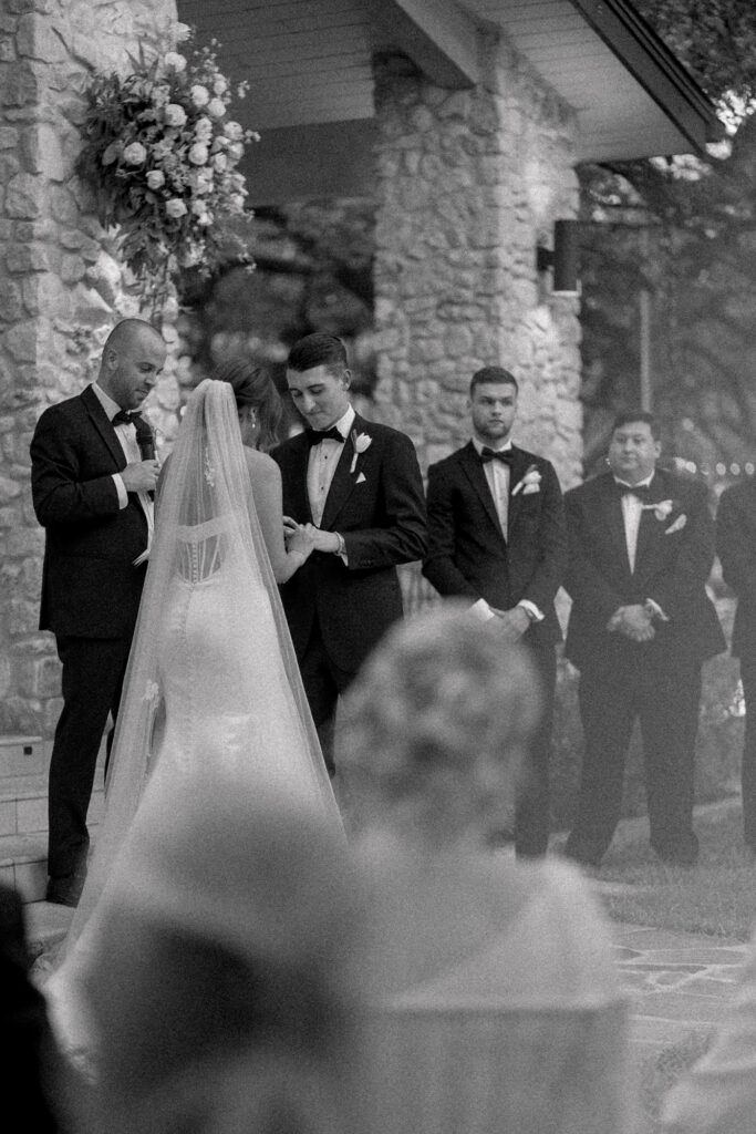 Groom receiving ring from bride during wedding ceremony at the Veranda in San Antonio