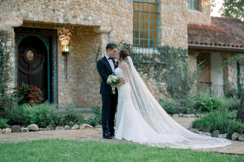 Bride and groom in front of the Estate House at the Veranda in San Antonio 