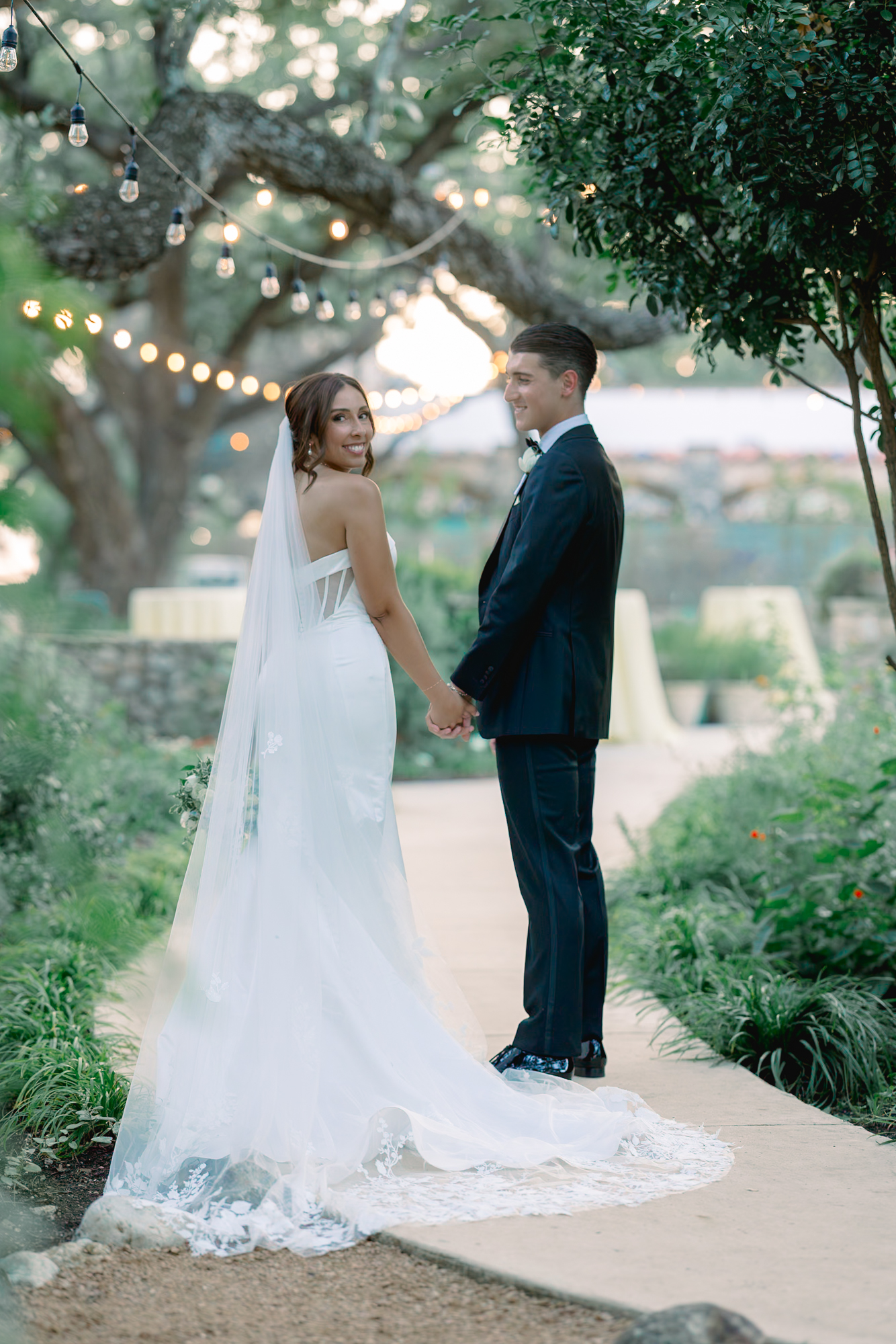 Bride and groom taking sunset photos in the courtyard of the Veranda in San Antonio