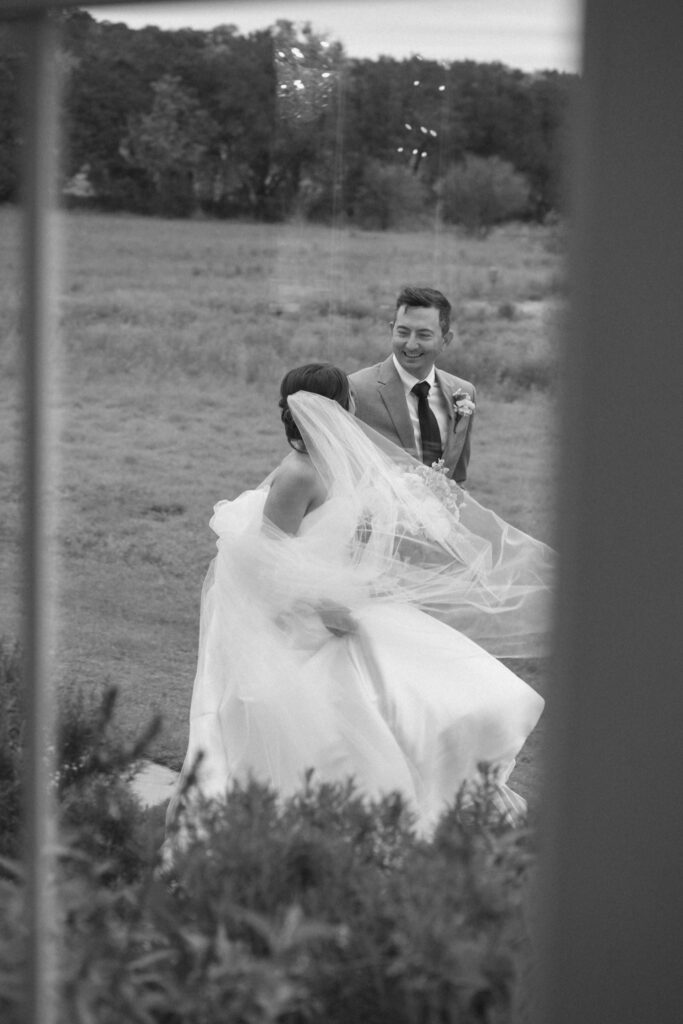 Bride and groom walking across Posey Meadows grounds