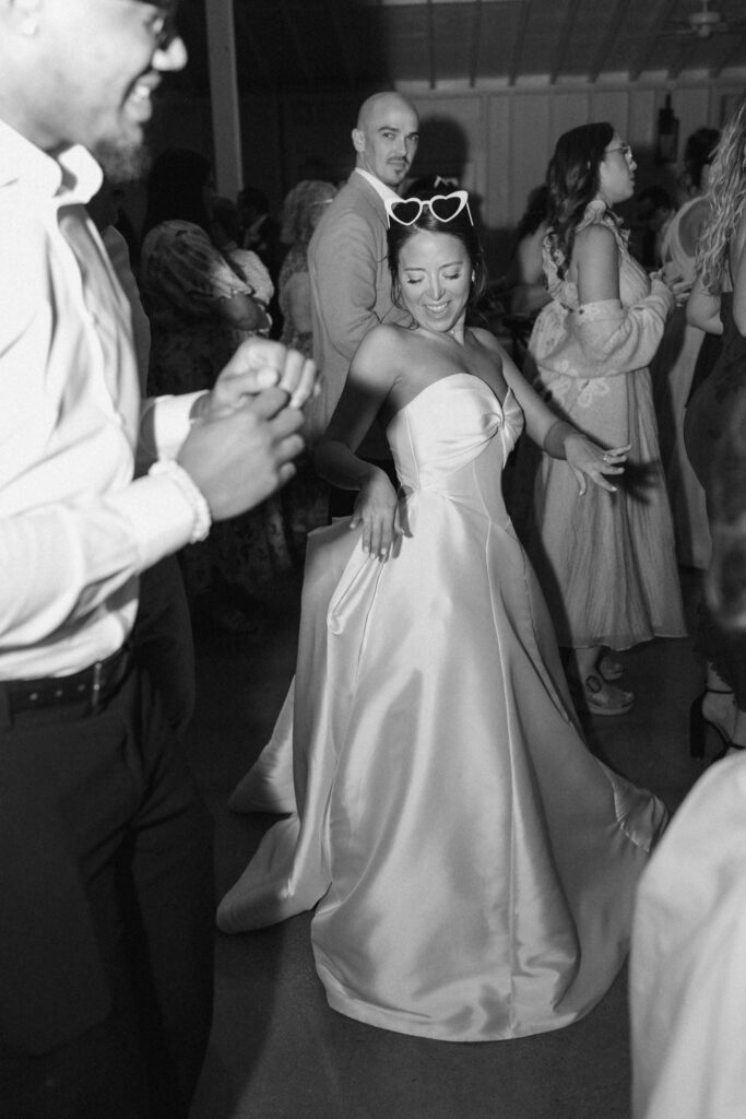 Bride dancing with guests at Posey Meadows