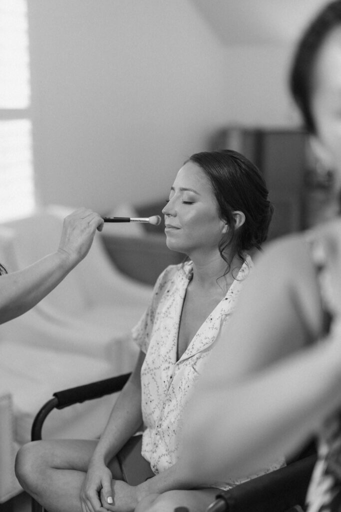 Bride getting her makeup done in the bridal suite at Posey Meadows