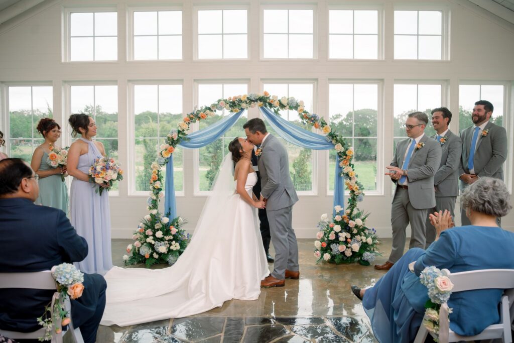 Bride and groom first kiss in Posey Meadows chapel