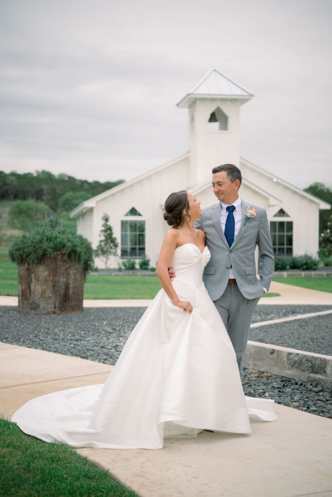 Bride and groom standing in front of the chapel at Posey Meadows