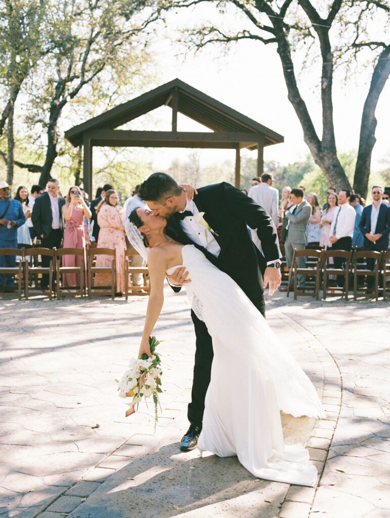 bride and groom kissing at Ranch Austin wedding venue