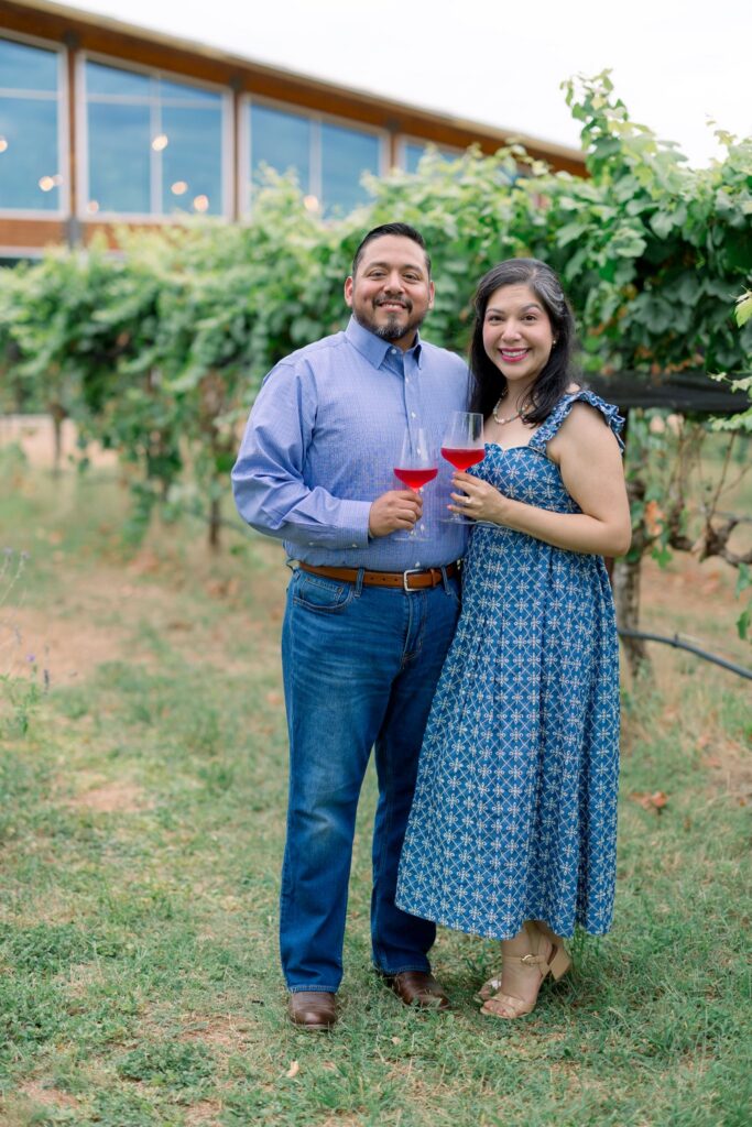 A newly engaged couple smiling outside William Chris Vineyards